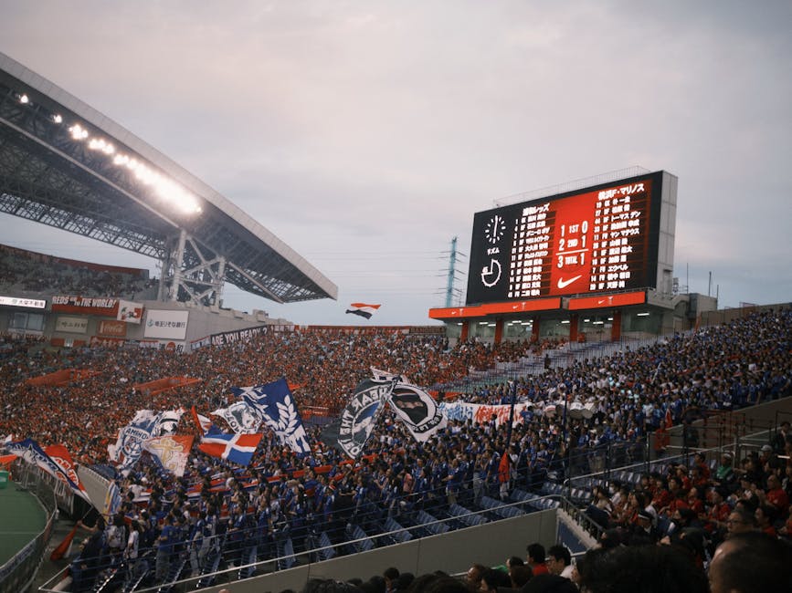 A vibrant soccer match with cheering fans at a packed stadium showcasing team spirit.